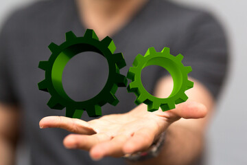 mechanism, green metallic gears and cogs at work on brown background. industrial machinery. 3d