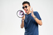 © Duck Stock - Handsome young man over isolated white background shouting through a megaphone