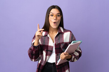 Wall Mural - Young student woman isolated on purple background intending to realizes the solution while lifting a finger up