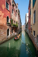 Gondola Ride On A Small Canal In Venice, Italy