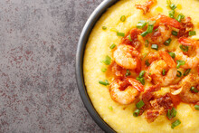 Delicious Yellow Grits With Cheese, Shrimps And Bacon Close-up In A Plate On The Table. Horizontal Top View From Above
