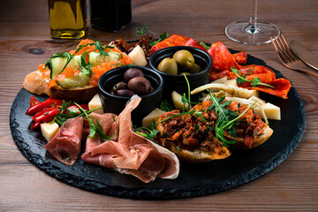 Wall Mural - Antipasto board with prosciutto, salami, cheese, olives