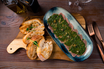 Wall Mural - Sliced Beef Tongue Slices on a platter and Dijon mustard on a wooden background