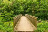 Fototapeta Pomosty - A wooden footbridge crossing the C & O Canal, at Chesapeake & Ohio Canal National Historical Park, Maryland.