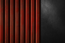 Red Metal Fence And Black Concrete Wall