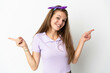 © luismolinero - Young caucasian woman over isolated background pointing finger to the laterals and happy