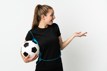 Wall Mural - Young football player woman isolated on white background with surprise expression while looking side