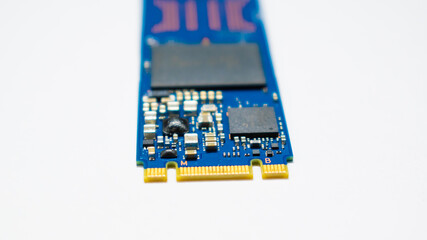 SSD hard drive NVMe version for slot M.2 laid on white background and narrow focus at pinout