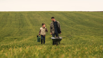 The father and son are going to work at the field