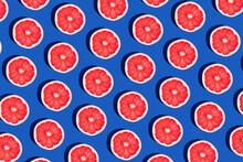 Minimal Fruit Pattern With Grapefruit On Blue  Background. Creative  Summer Mood. Healty Concept. Organic Fruit. Flat Lay. Trendy Social Mockup Or Wallpaper.