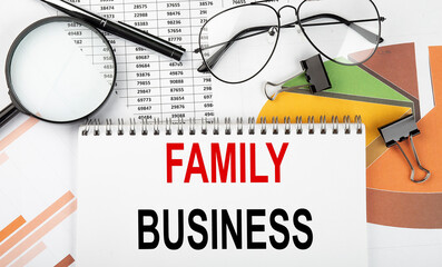 Poster - Text FAMILY BUSINESS on white paper notebook on the diagram. Business concept