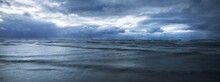 Dark Storm Sky Above The Baltic Sea, Waves And Water Splashes. Dramatic Cloudscape. Nature, Environment, Fickle Weather, Climate Change. Atmospheric Scenery. Panoramic View, Long Exposure