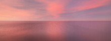 Baltic Sea Under The Colorful Sunset Sky. Stunning Seascape. Golden Sunset Light Through The Pink Clouds. Long Exposure. Tranquility Scene. Riga Bay, Latvia
