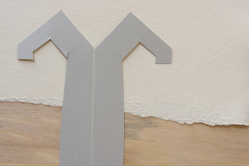 paper shape with two arms on torn paper and wood