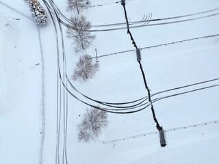 Poster - aerial view of parking lot after snow with tree and track