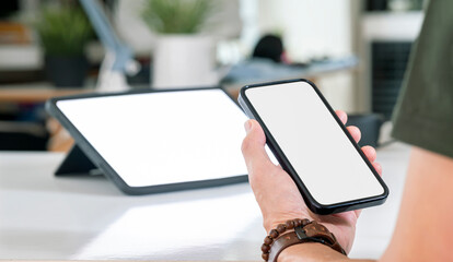 Wall Mural - closeup view of asian man holding in hands smartphone with empty blank mockup screen for advertising
