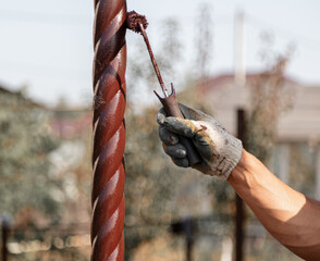 Wall Mural - A worker paints a metal pipe