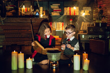 Little Wizards Read Magic Book And Brew A Potion . Halloween Party. Cosplay Harry Potter