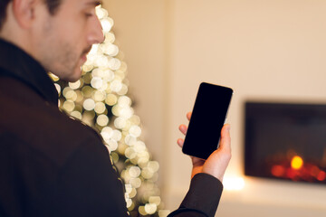 Poster - Man holding phone with empty mockup screen