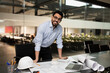 © Prostock-studio - Smiling millennial attractive muslim engineer builder in glasses working on desk with project drawings