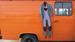 Neoprene wetsuit hanging in the caravan orange