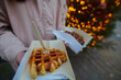 Close up of a freshly baked waffle in the historic city centre of Bruges in Belgium