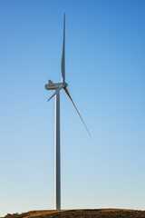 Wall Mural - wind turbines on a beautiful blue sky in a mountain wind farm in sardinia. renewable energy concept,