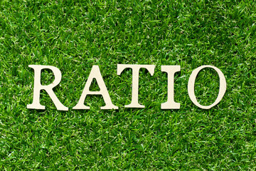 Wood letter in word ratio on green grass background