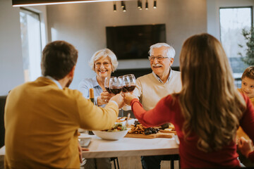 Wall Mural - Happy family having dinner with red wine at home