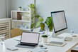 © Seventyfour - Background image of office workplace with mock up computer screens on white desk, copy space