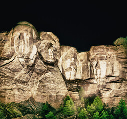 Fototapete - Mt. Rushmore national memorial park in South Dakota at night, presidents faces illuminated against black sky