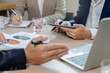 © Pormezz - Close up hands of a businessman holding pen on the meeting conference table.