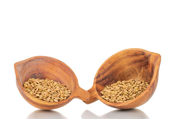 Raw organic green lentils in two wooden cups, macro, isolated on white.