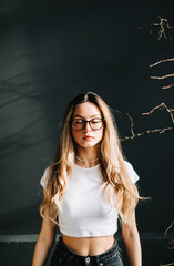 Wall Mural - Portrait of young caucasian woman with closed eyes and blonde hair, over black background.