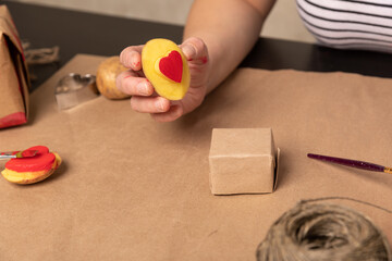 Wall Mural - heart shaped potato stamp on craft paper. The process of decorating a gift for Valentine's Day. Getting ready for the celebration on February 14th.