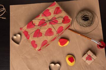 heart shaped potato stamp on craft paper. The process of decorating a gift for Valentine's Day. Getting ready for the celebration on February 14th.