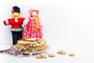 Wall Mural - Background with pancakes, textile dolls, sushki, wooden spoon with caviar and pussy-willow for Maslenitsa festival.