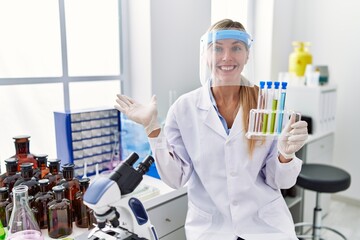 Sticker - Beautiful woman working at scientist laboratory celebrating achievement with happy smile and winner expression with raised hand