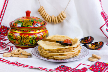 Wall Mural - Background with pancakes, wooden utensils with Khokhloma painting, rushnik, sushki for Maslenitsa festival.