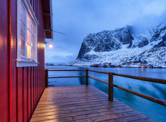 Wall Mural - View on the house in the Lofoten Islands, Norway. Landscape in winter time during blue hour. Mountains and water. Travel image.