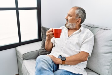 Canvas Print - Senior grey-haired man smiling confident drinking coffee at home