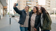 © Krakenimages.com - Mother and daugthers making selfie by the smartphone standing together at street
