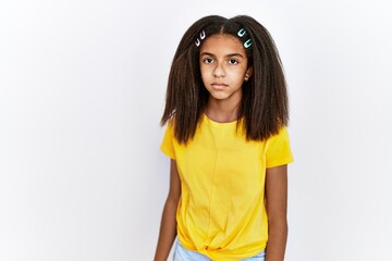 Poster - Young african american girl standing over white isolated background relaxed with serious expression on face. simple and natural looking at the camera.