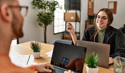 Canvas Print - Two caucasian business executives working at the office.