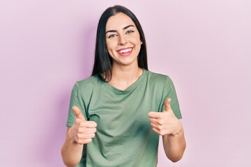 Sticker - Beautiful woman with blue eyes wearing casual t shirt success sign doing positive gesture with hand, thumbs up smiling and happy. cheerful expression and winner gesture.