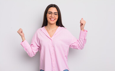 Wall Mural - pretty young woman looking extremely happy and surprised, celebrating success, shouting and jumping