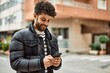 © Krakenimages.com - Young arab man using smartphone outdoor at the town
