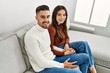© Krakenimages.com - Young hispanic couple hugging and resting on the sofa and at home.