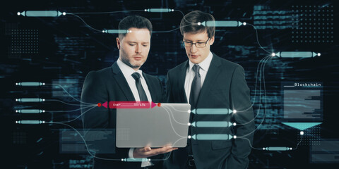 Poster - Two attractive european businessmen using laptop with abstract glowing big data blockchain interface on dark background. Cryptocurrency, finance, big data and information concept. Double exposure.