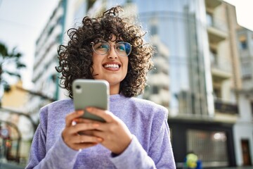 Sticker - Young middle east woman smiling confident using smartphone at street